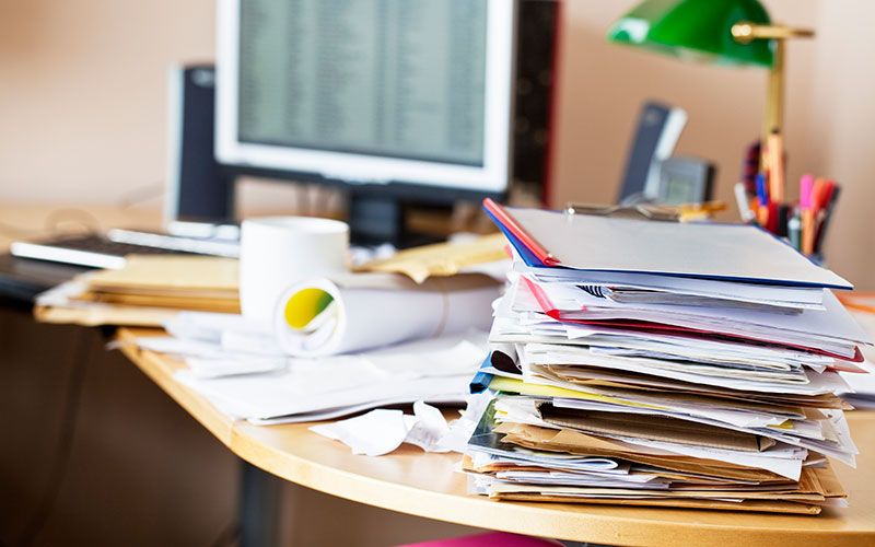Desk covered in paperwork